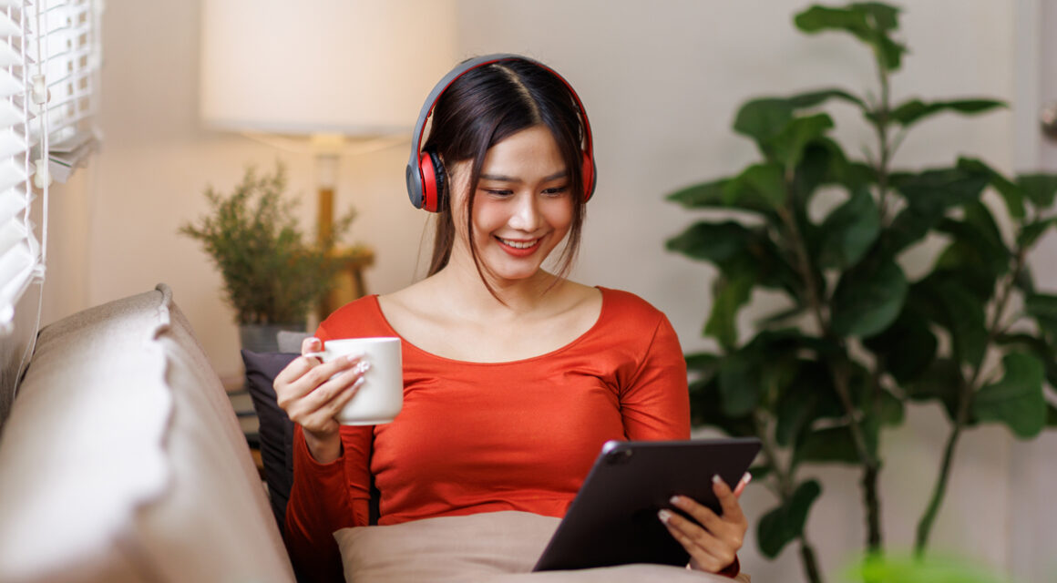 Girl with headphones drinking coffee