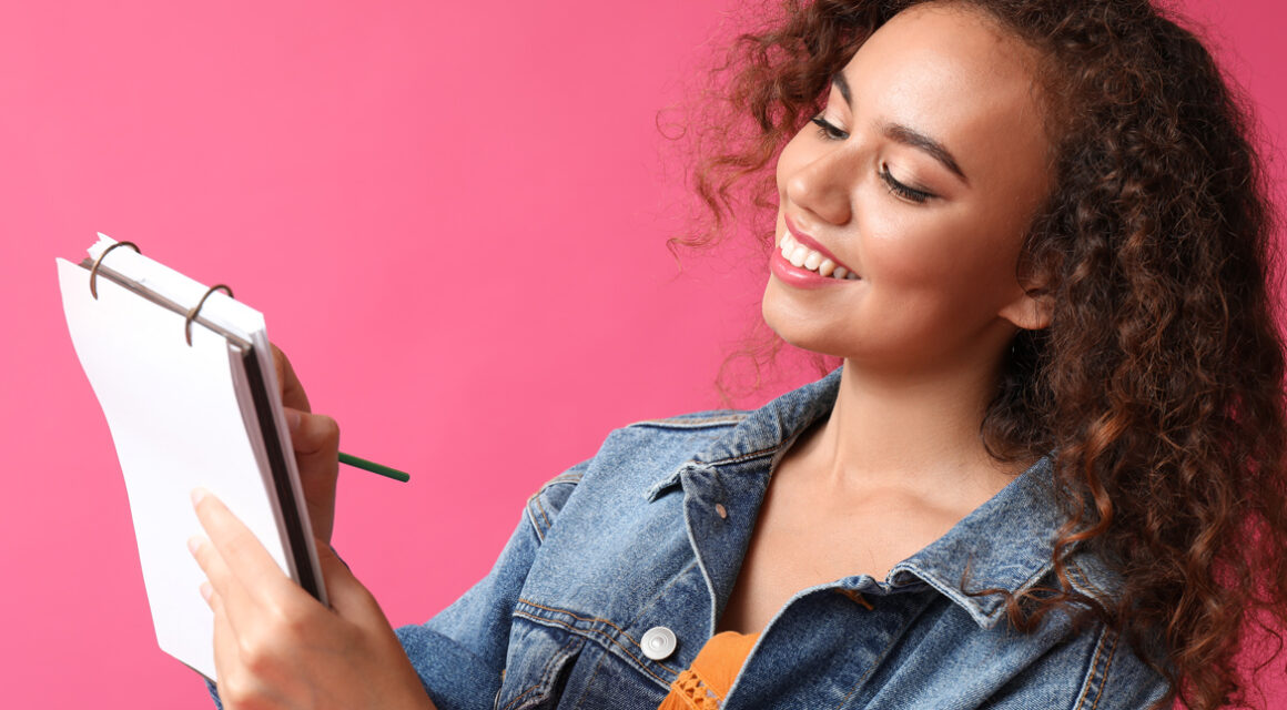 Woman writing on a notepad