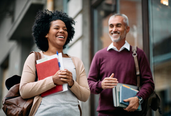 Man and women walking outside of a college