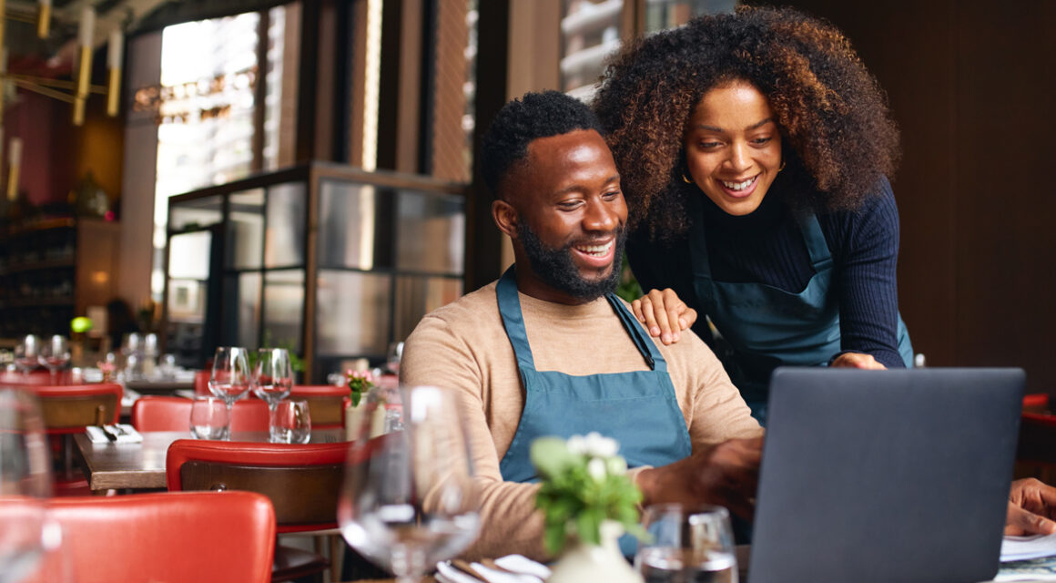 Two people looking at laptop screen