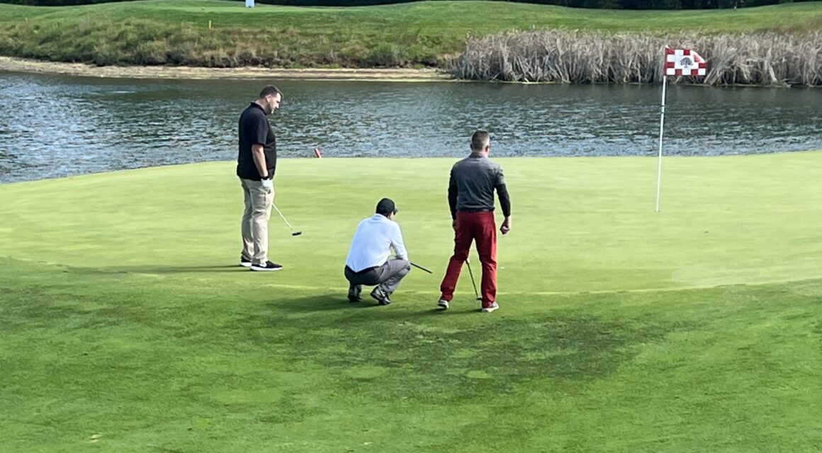 Men playing golf on a golf course
