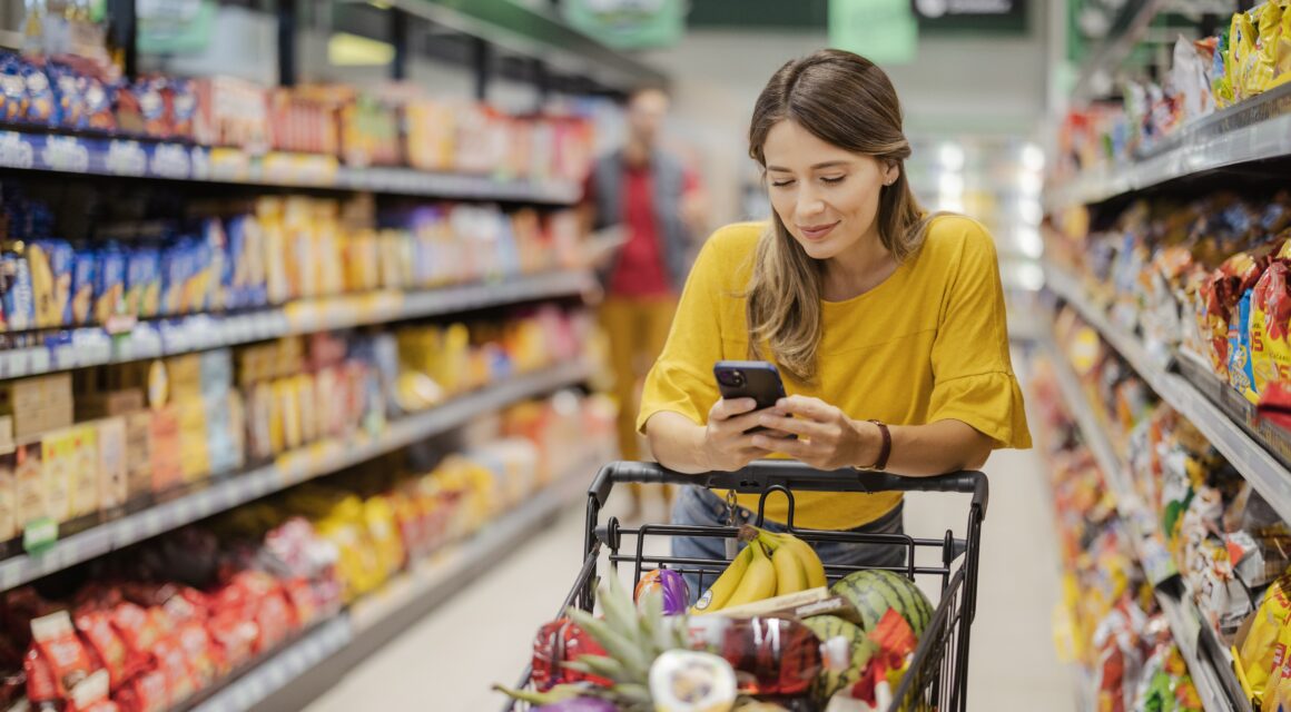 Woman at a grocery store with a cart